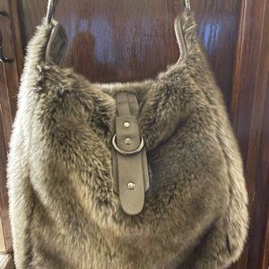 Super cute faux fur purse with leather strap.